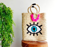 Load image into Gallery viewer, STRAW TOTE BAG HANDMADE EVIL EYE PINK POMPOMS